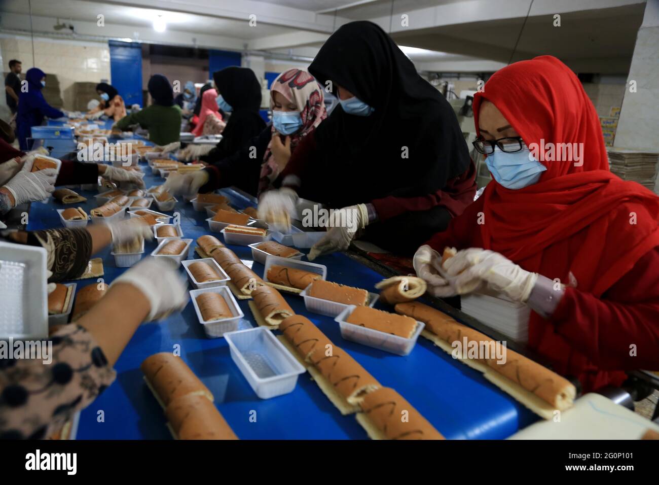 Herat, Afghanistan. 2nd June, 2021. Afghan women work at a cake factory in an industrial park in Herat province, Afghanistan, on June 1, 2021. Peace and security in Herat city has facilitated investors to pour their capital into more than 300 plants. In the industrial park of the western Herat province, more than 300 factories and plants are operational to produce a variety of items ranging from food stuff to detergent and construction materials. Credit: Arif Karimi/Xinhua/Alamy Live News Stock Photo