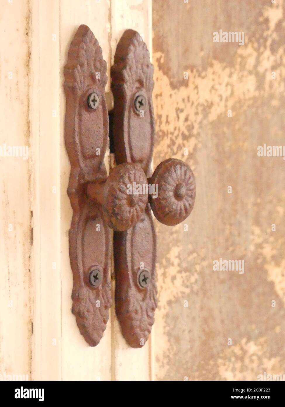 Closeup of vintage rusty handles on the weathered doors Stock Photo