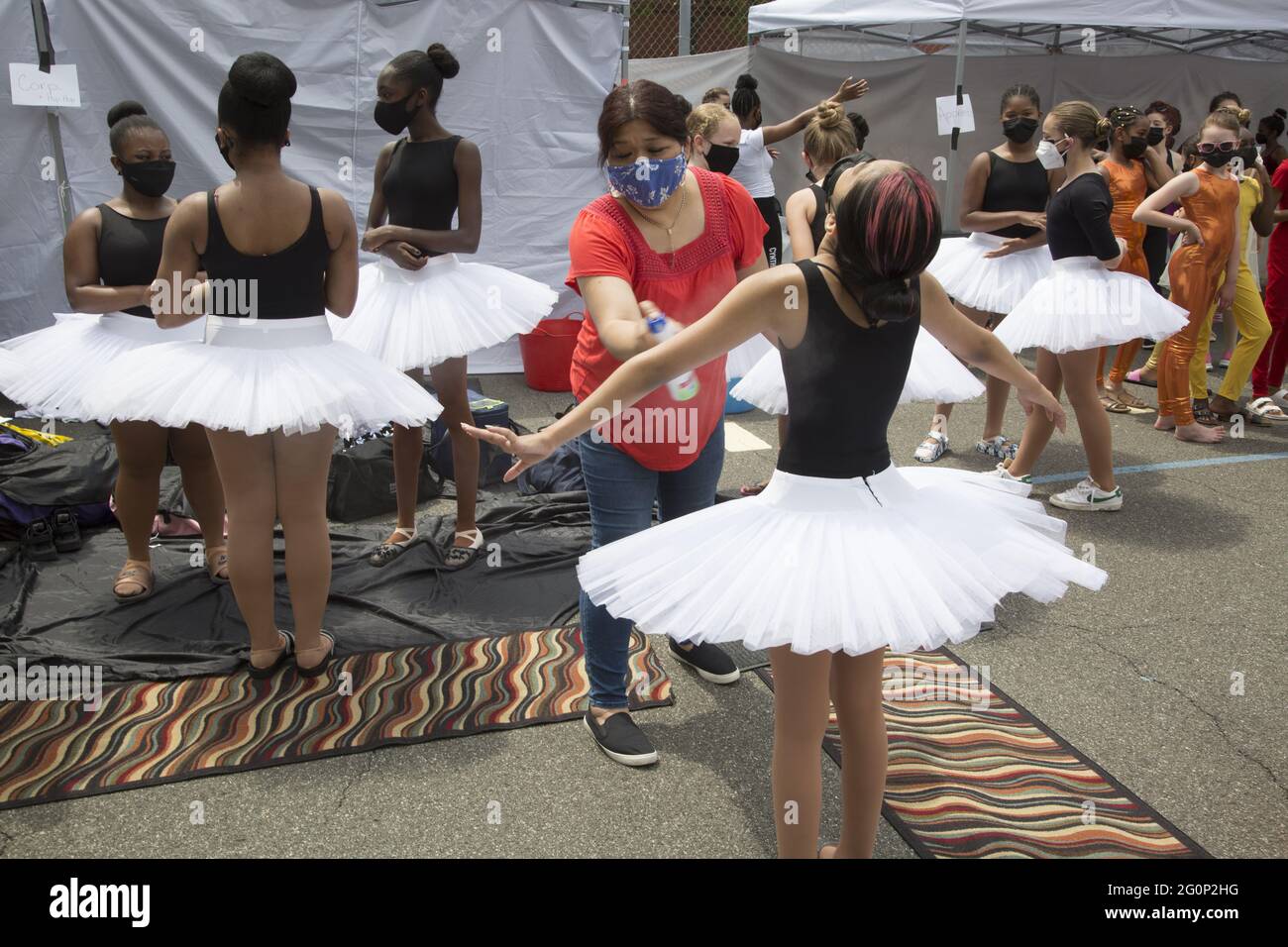 Cynthia KIng Dance Studio for kids in Brooklyn, New York holds its first performance outdoors, with masks and social distancing in the spring 2021 since the pandemic and city shutdown began over a year earlier. Preparing to perform. Stock Photo