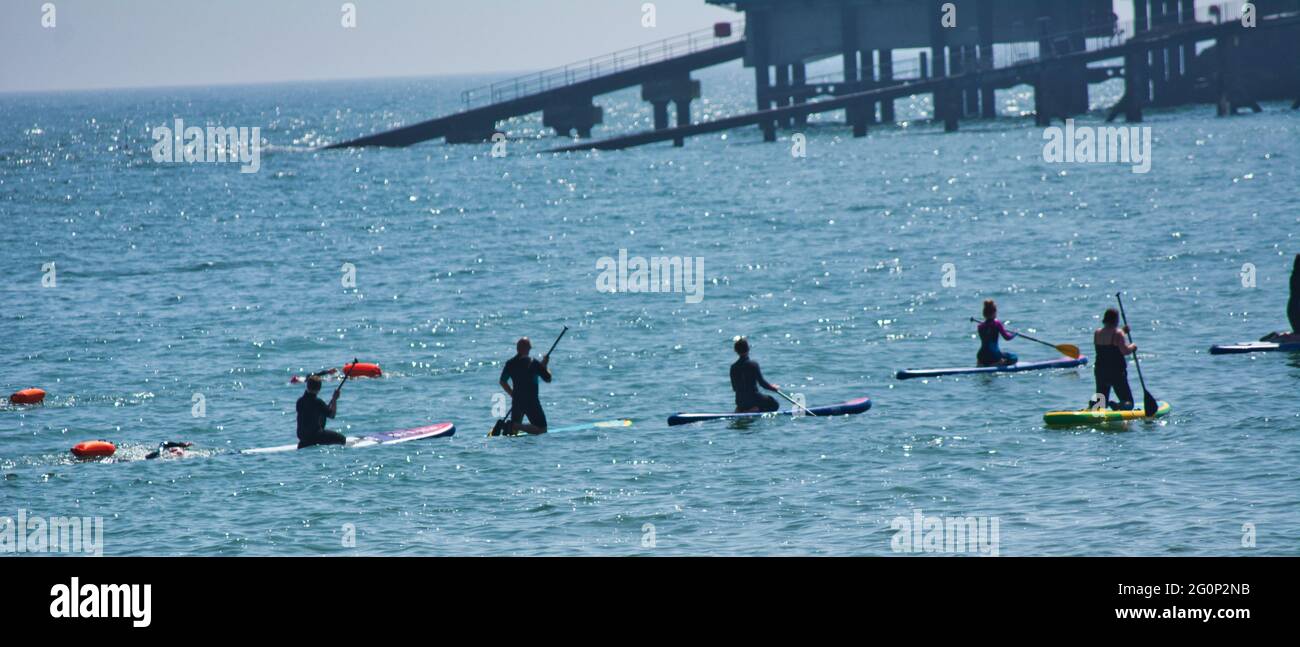Paddle boarding lesson in Tenby,Wales,UK Stock Photo - Alamy