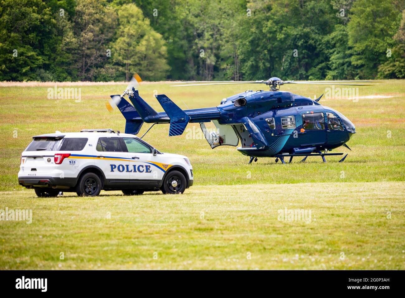 Paramedic helicopter with police car emergency service on the field at day Stock Photo Alamy