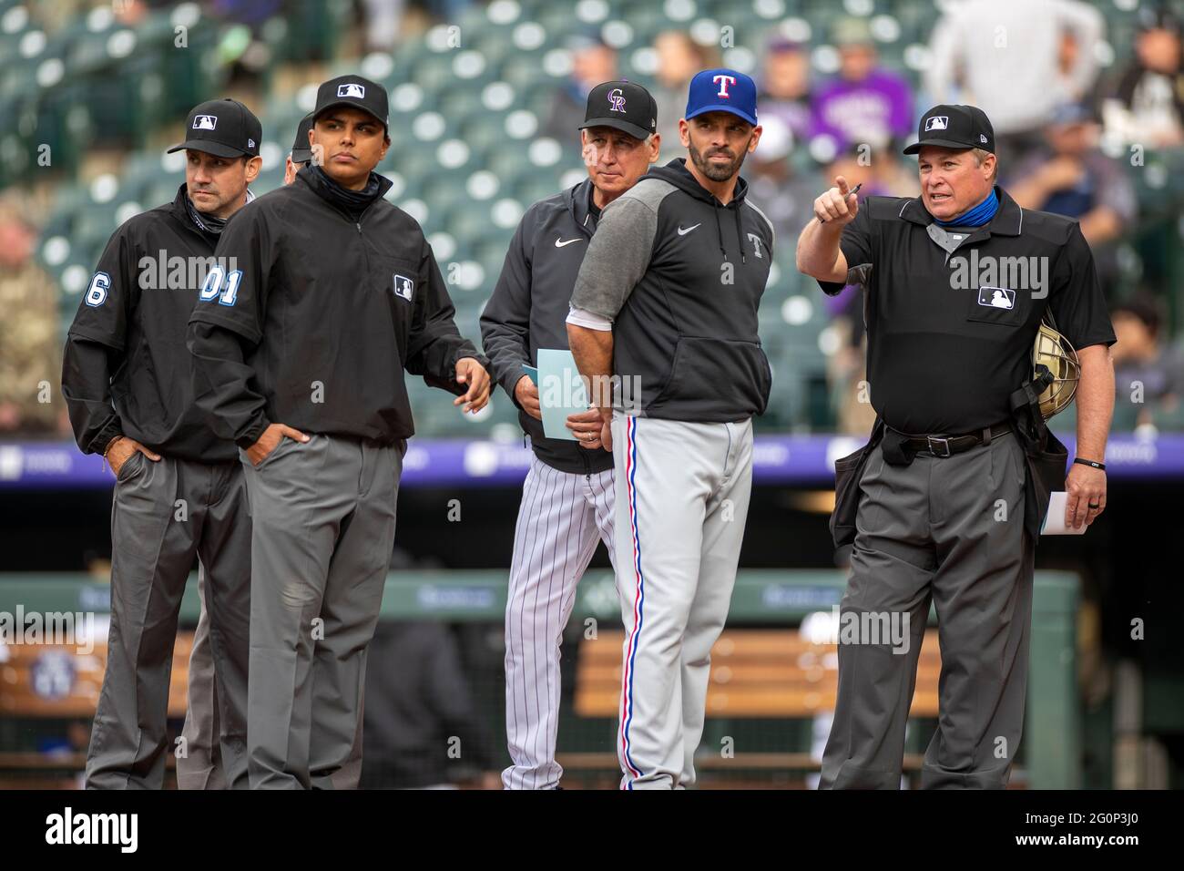Colorado Rockies manager Bud Black and Texas Rangers manager Chris Woodward meet with MLB umpires before an MLB regular season game, Tuesday, June 1, Stock Photo