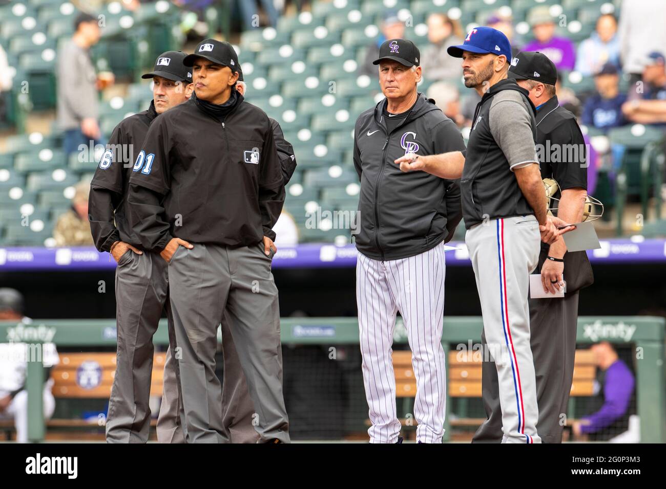 Colorado Rockies manager Bud Black and Texas Rangers manager Chris Woodward meet with MLB umpires before an MLB regular season game, Tuesday, June 1, Stock Photo