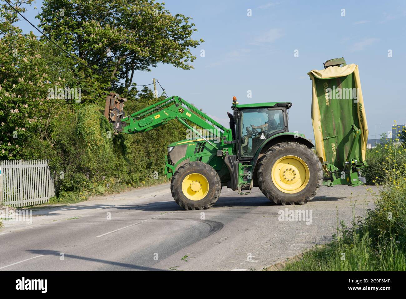 JOHN DEERE Tractor, cutting grasses and weed in farm field, countryside