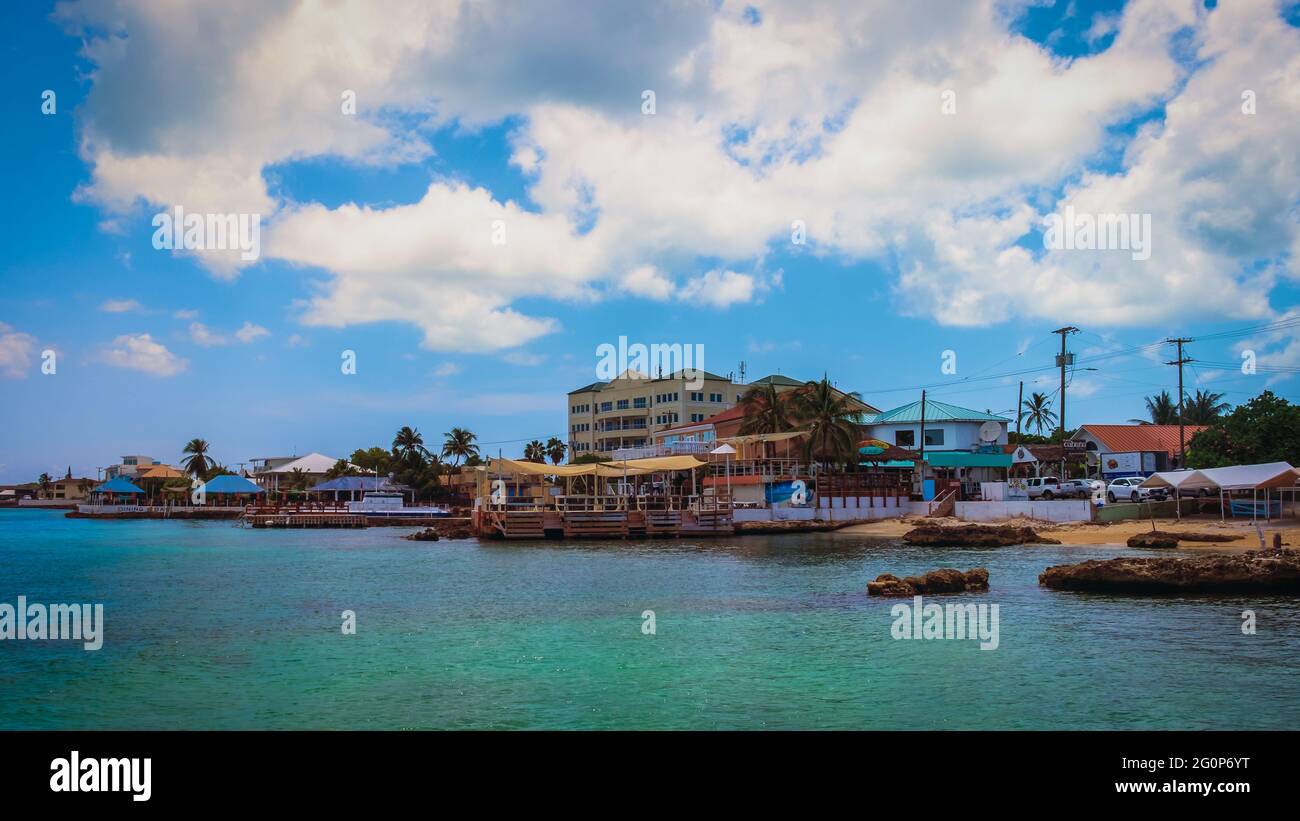 Grand Cayman, Cayman Islands, July 2020, view of some buildings with restaurants and stores by the Caribbean Sea Stock Photo