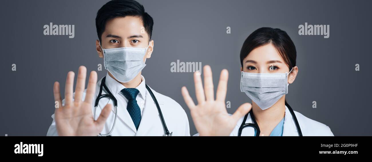 Doctor in face mask and showing stop sign with hands Stock Photo - Alamy