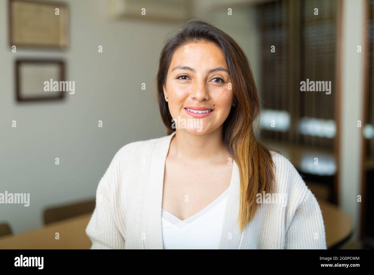 Young smiling hispanic woman standing in office meeting room Stock ...