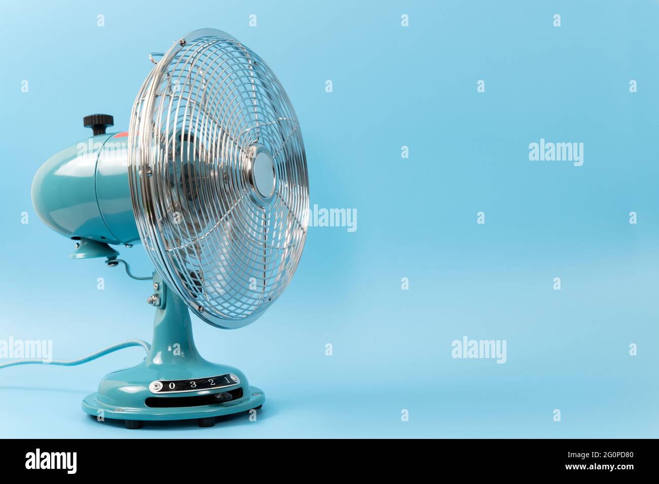 Vintage tabletop fan isolated on a blue background Stock Photo
