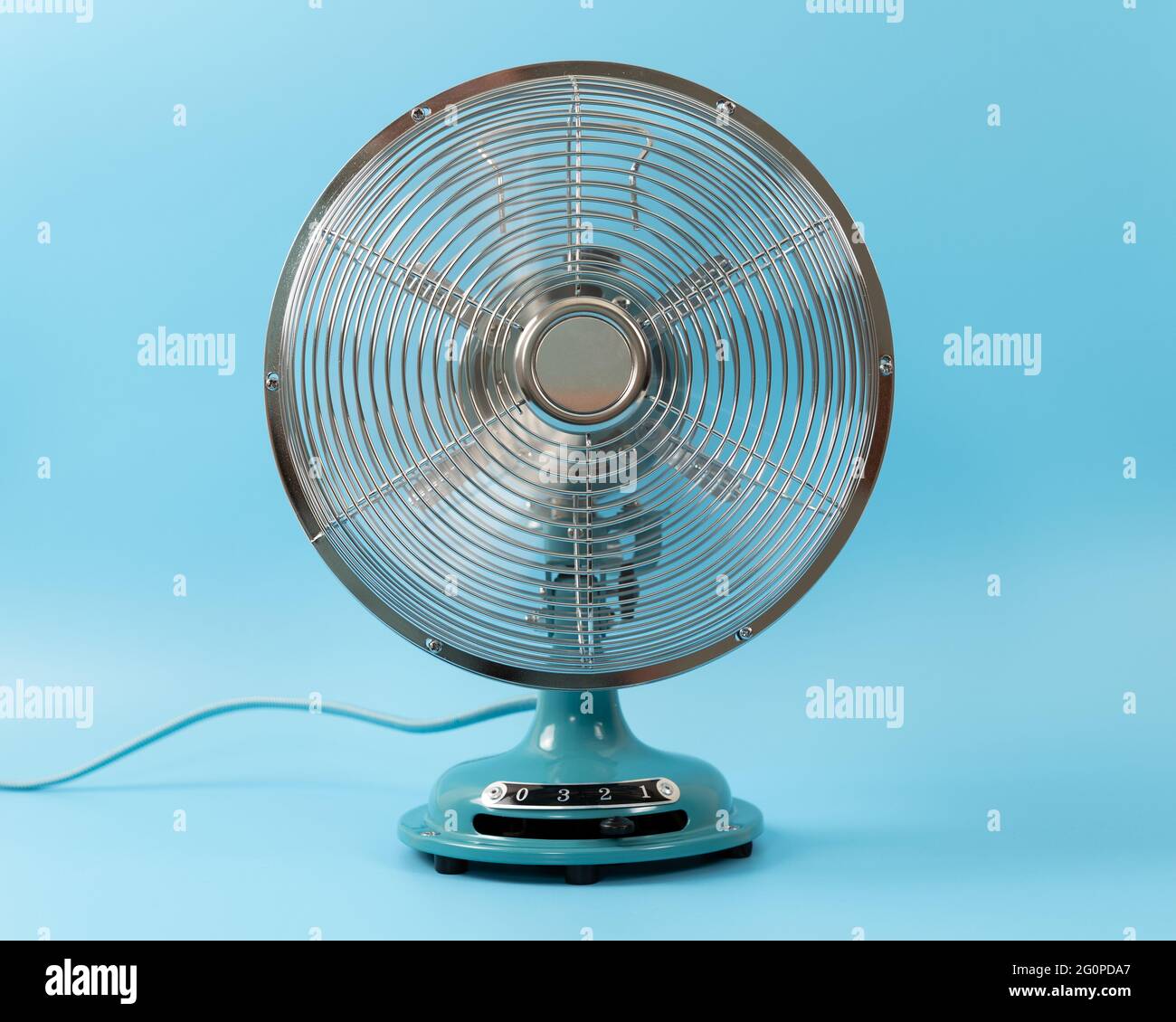 Vintage tabletop fan isolated on a blue background Stock Photo