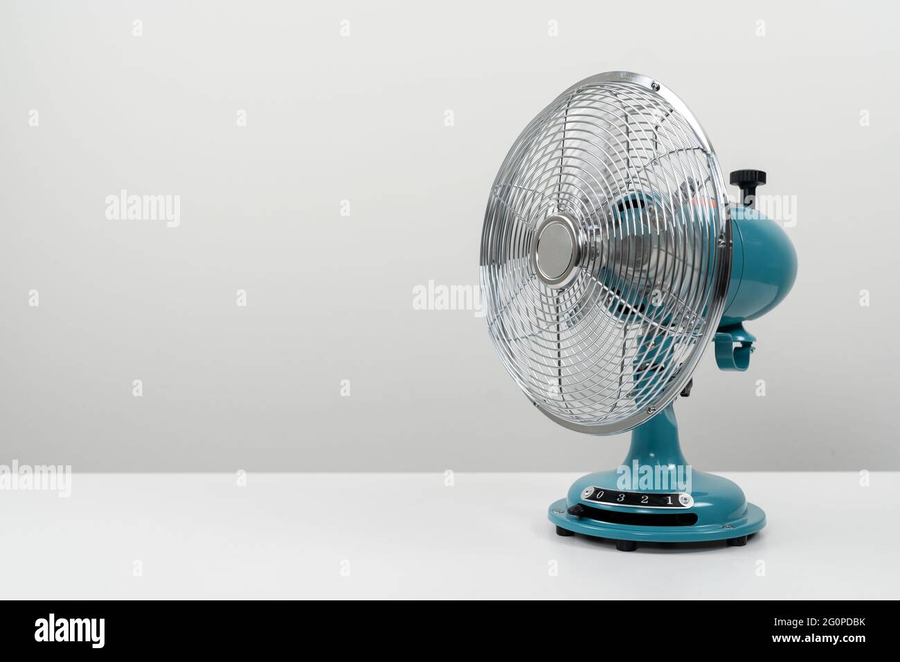 Vintage blue tabletop fan isolated on a white background Stock Photo