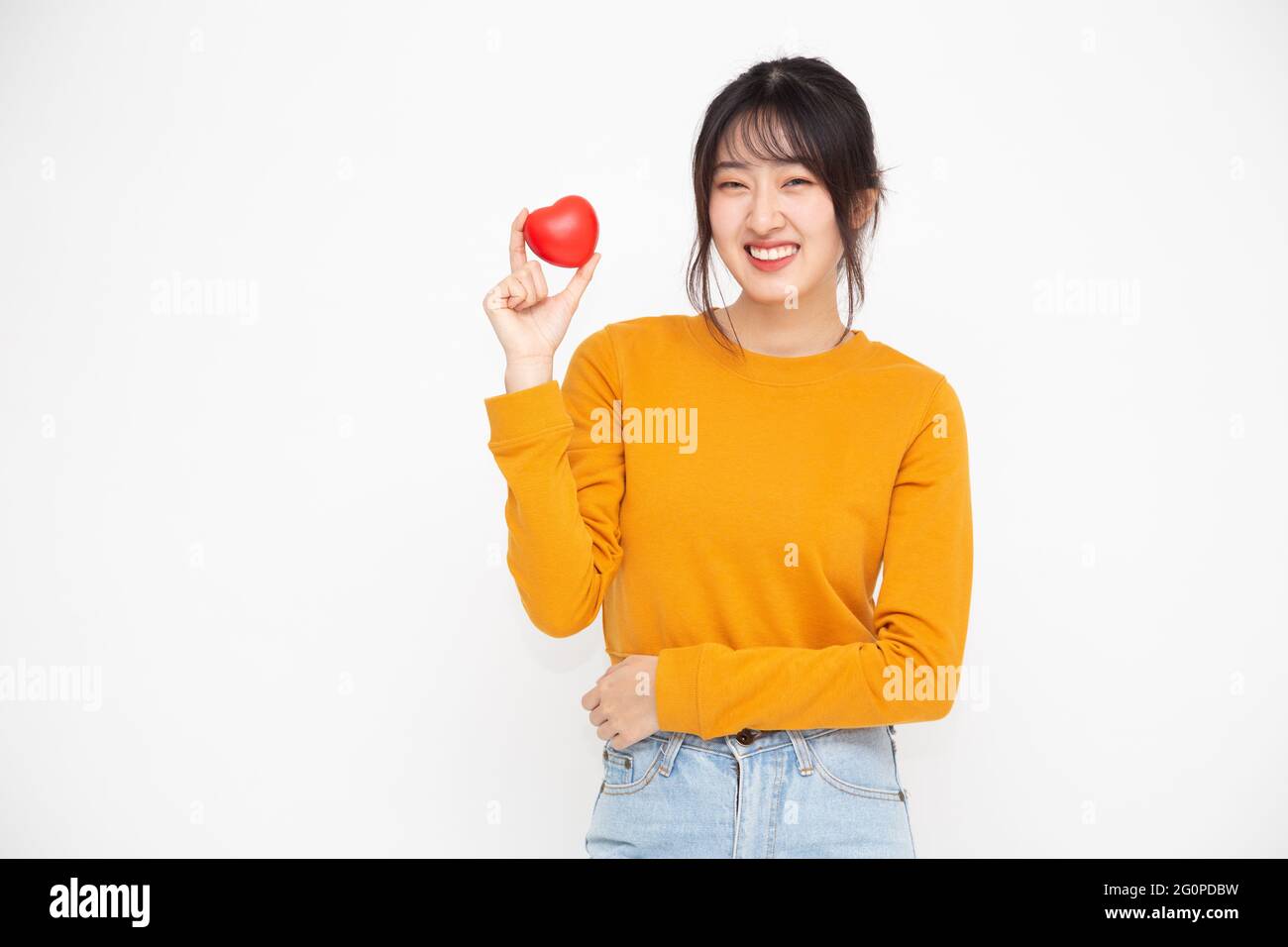 Young Asian woman holding red love heart isolated on white background ...