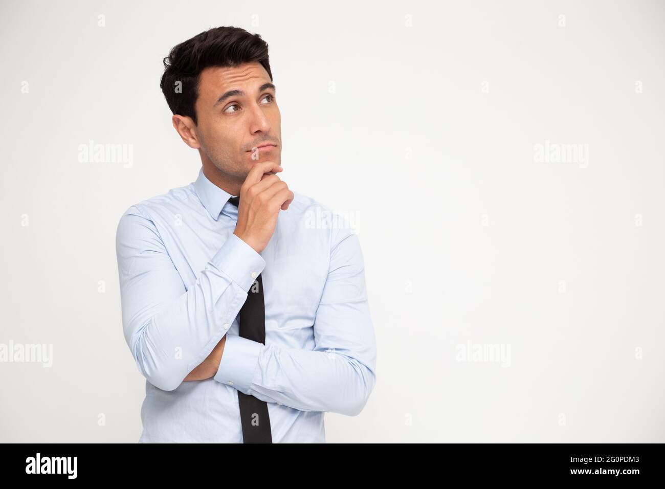 Portrait of Young businessman thinking and looking aside isolated on white background Stock Photo