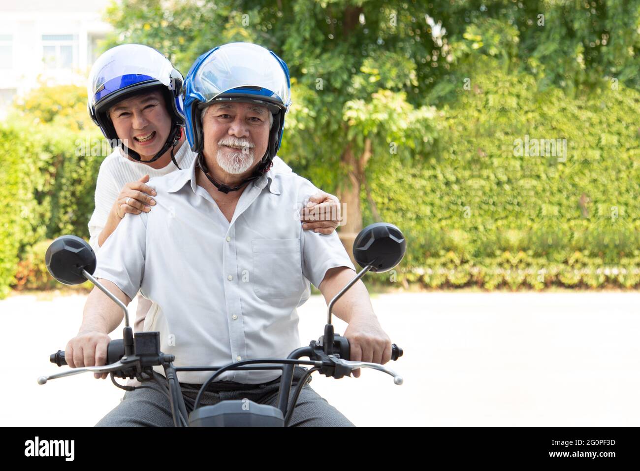 Senior asian couple riding motorcycle, Happy active old age and lifestyle concept Stock Photo