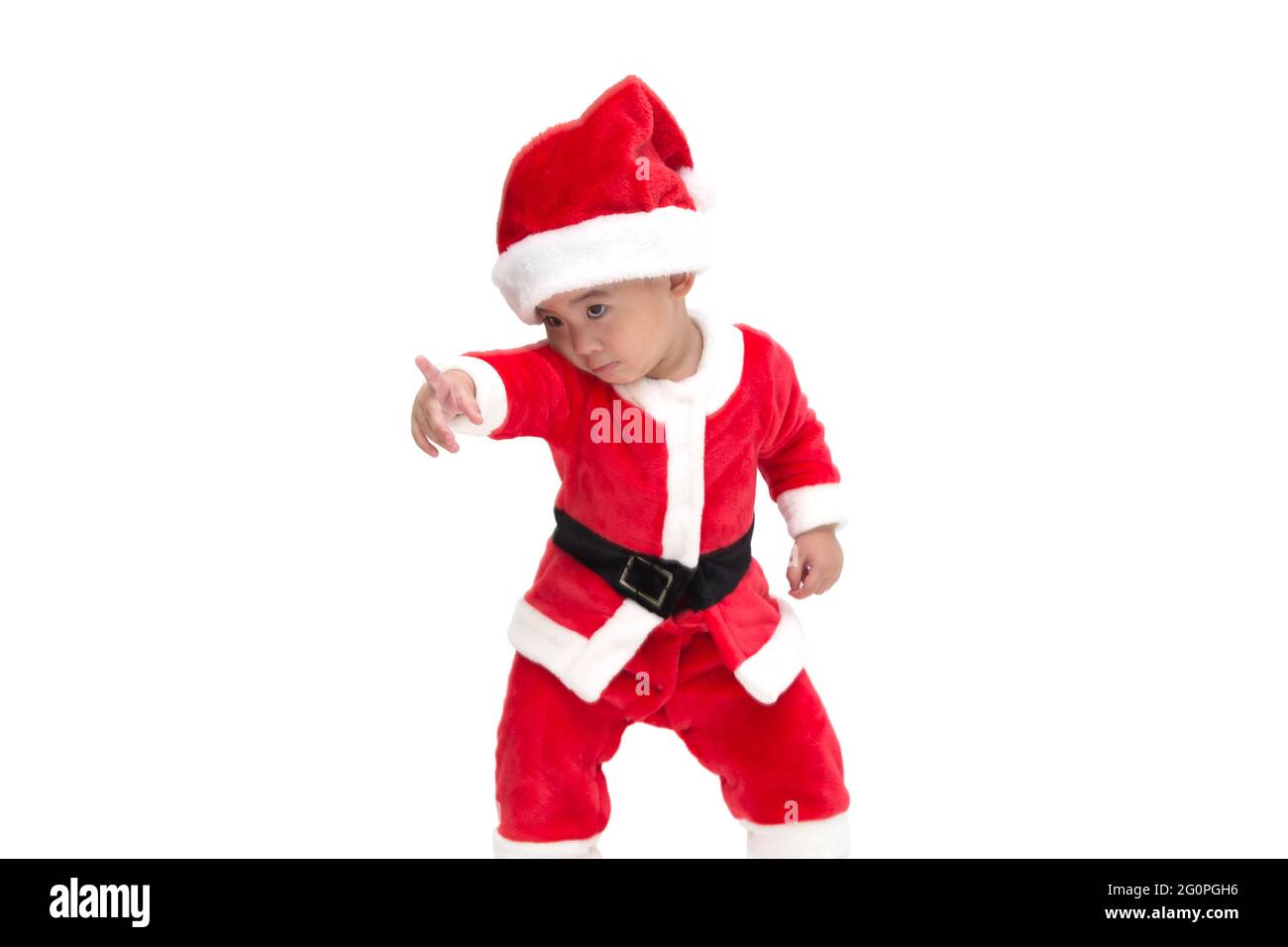 Asian baby boy in a Christmas costume Santa Claus pointing fingers and shows something amazing at the front isolated on white background, Shocked, Sur Stock Photo