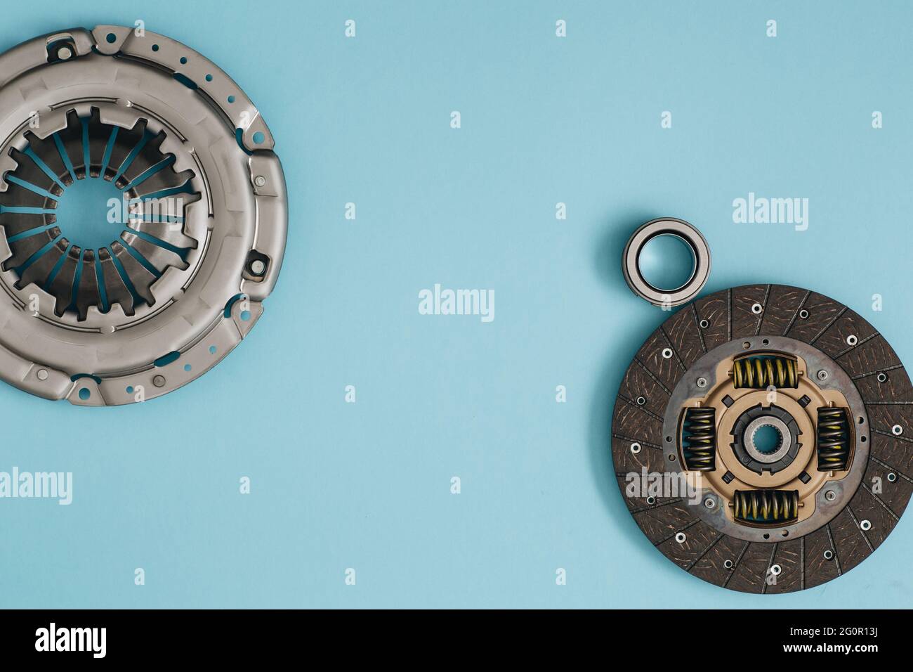 Automotive clutch mechanism, disc, basket and bearing for auto on a blue background. Car parts. Copy space. Flat lay Stock Photo