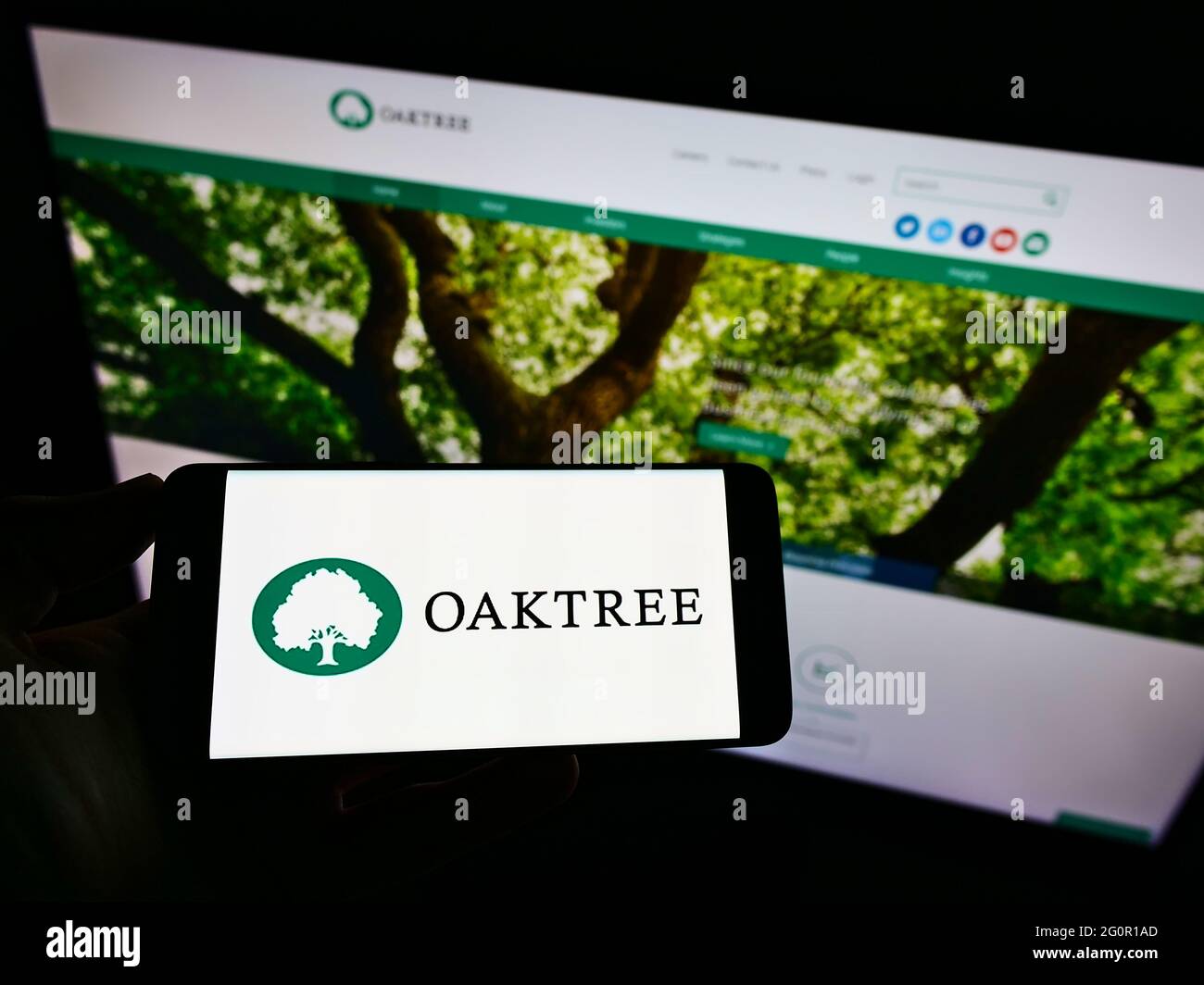 Person holding smartphone with logo of US investment company Oaktree Capital  Management Inc. on screen in front of website. Focus on phone display Stock  Photo - Alamy