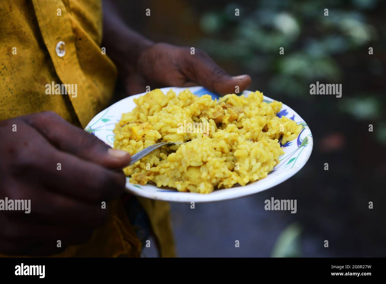 Bangladeshi men enjoying a traditional Kitchri rice breakfast at the ...