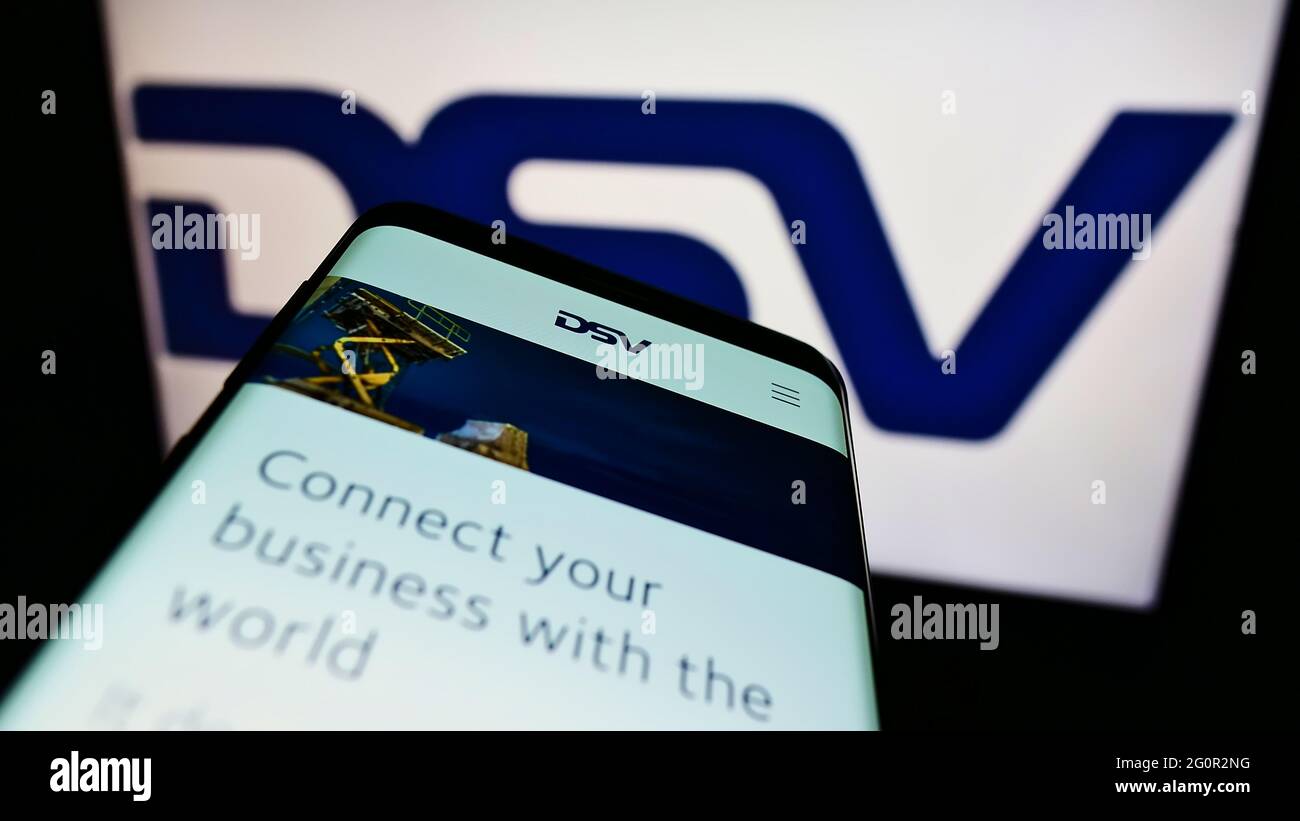 Smartphone with website of Danish logistics company DSV Panalpina AS on screen in front of business logo. Focus on top-left of phone display. Stock Photo
