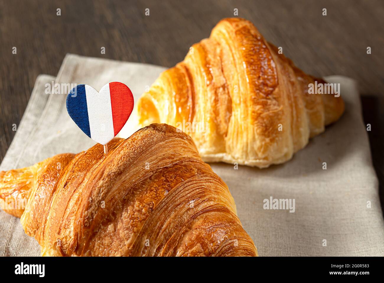 French croissants and a heart in the colors of the French flag on a table Stock Photo