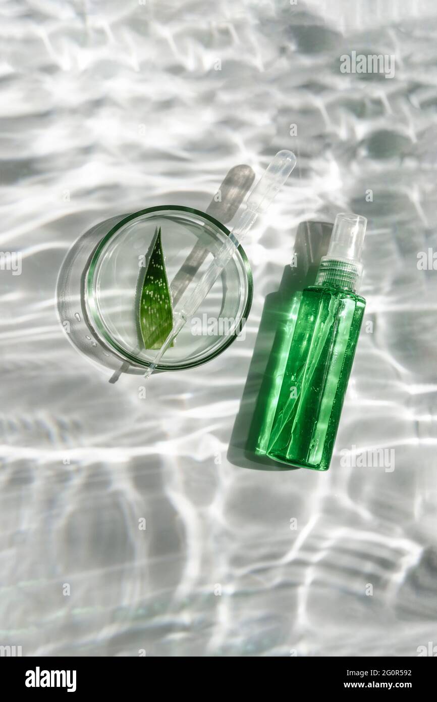 Aloe vera gel or sun shade serum. On a white background with reflections of  water. View from above Stock Photo - Alamy