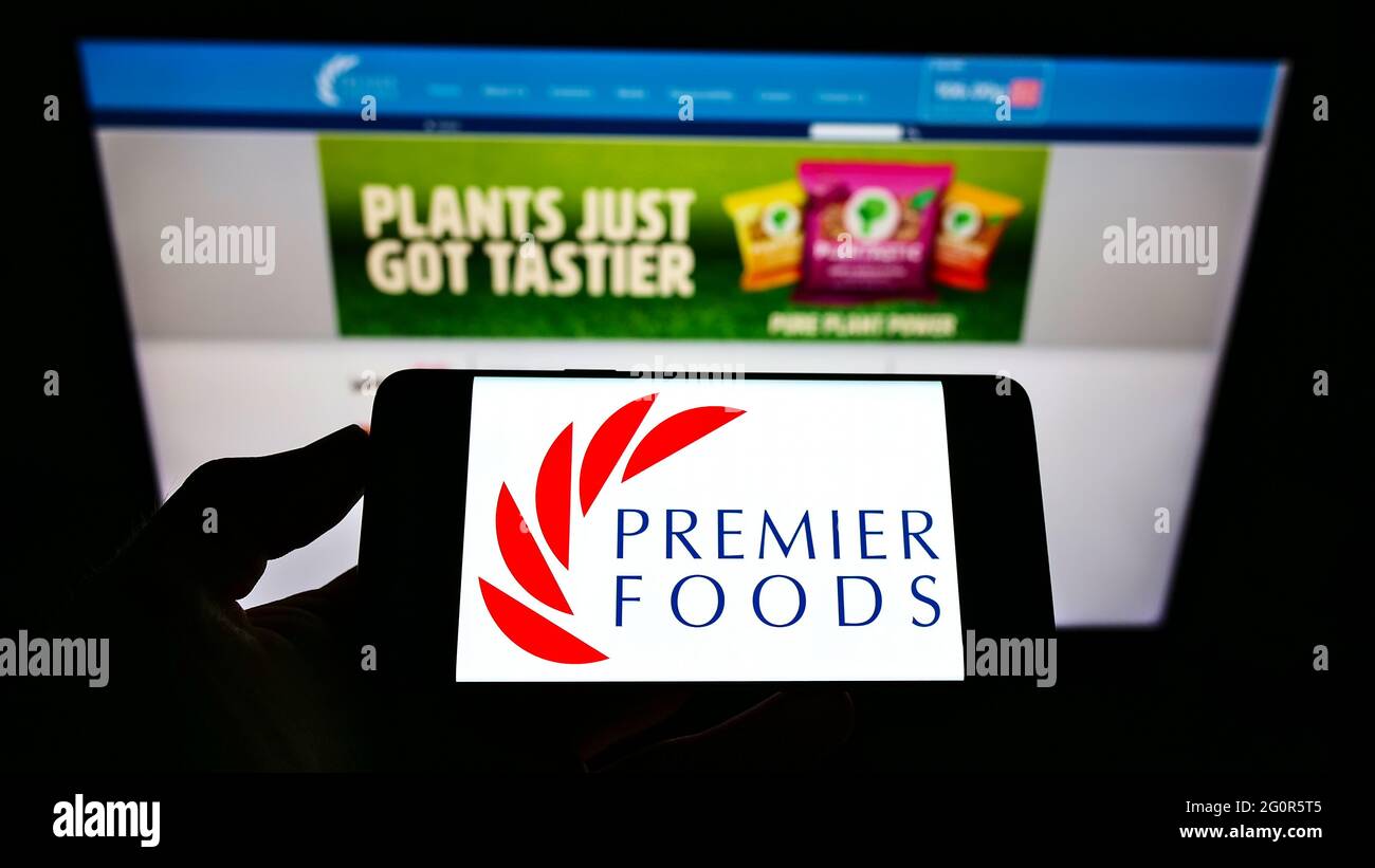 Person Holding Smartphone With Logo Of British Food Manufacturer