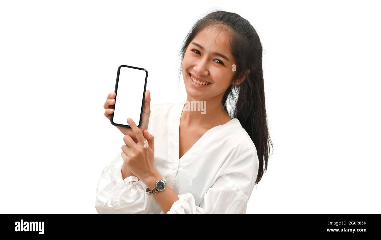 Pretty female smiling and presenting smartphone with mock-up screen ...