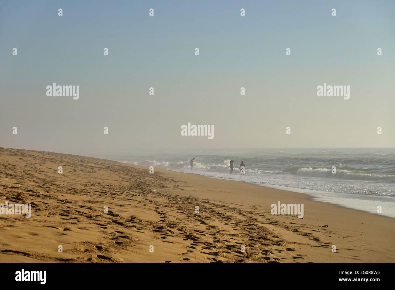 Stunning view of sandy beach under a blue cloudless sky and people ...