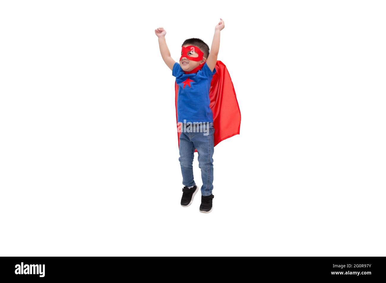 Asian boy jumping with funny little power of hero isolated on white background, Superhero concept Stock Photo