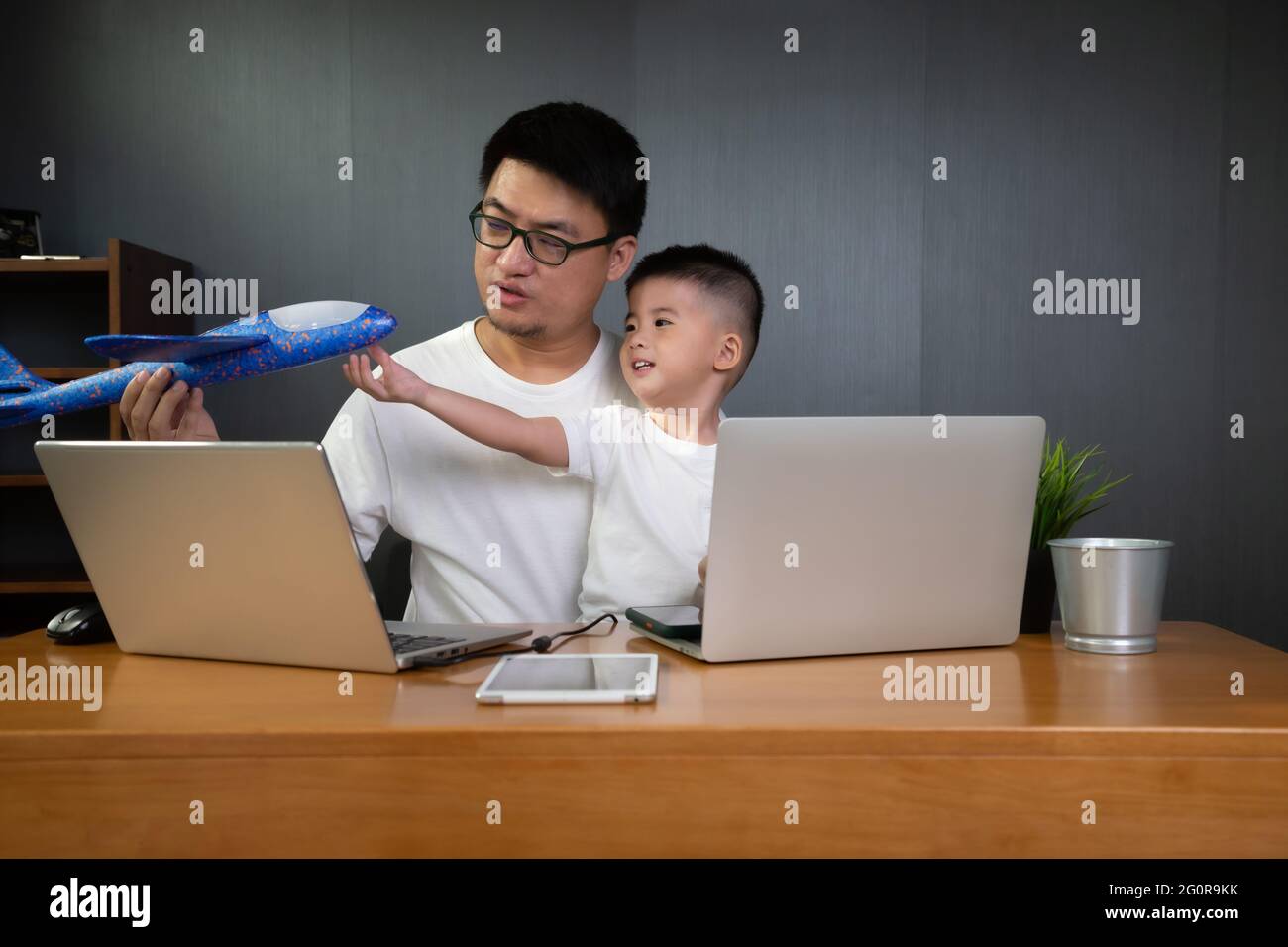 Asian man it support working on computer laptop to remote desktop with ...