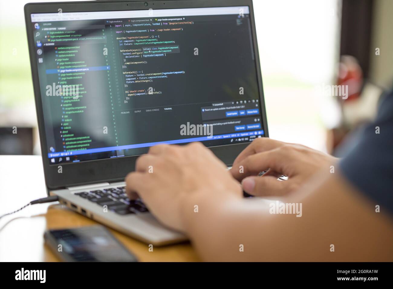 Freelance programmer or developer working at home and typing source code with laptop Stock Photo