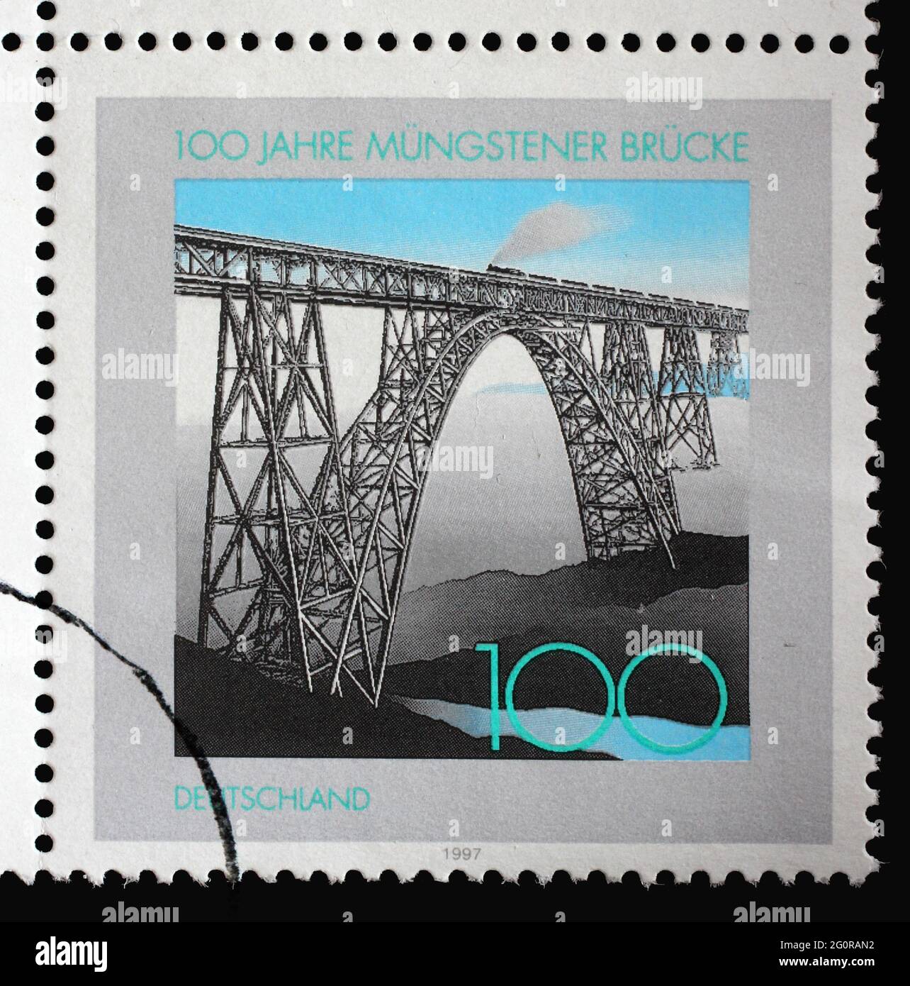 A stamp printed in Germany shows Train on Müngsten Railway Bridge, Centenary of Müngsten Railway Bridge, circa 1997 Stock Photo