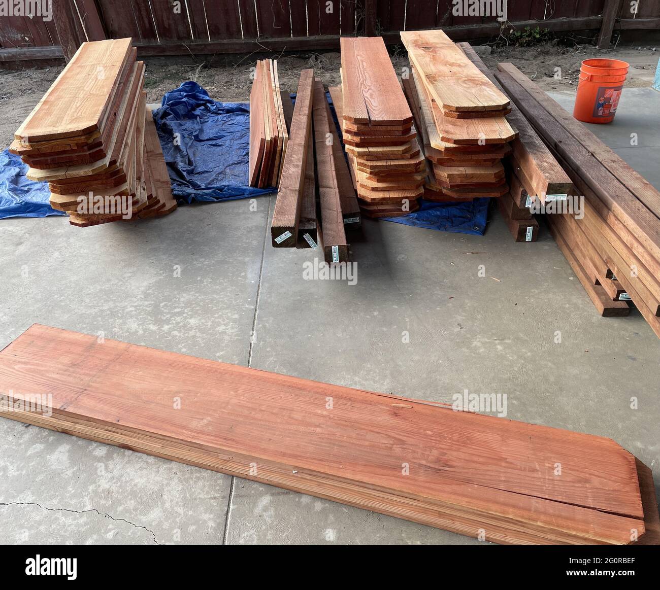 Stacks of new redwood picket fence boards on a patio Stock Photo Alamy