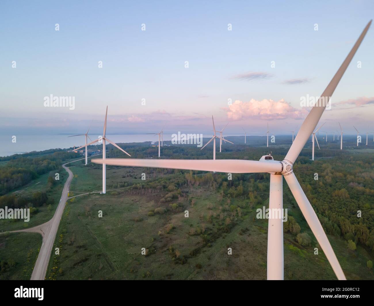 Wind turbines on sunset at summer evening. Renewable energy Stock Photo ...