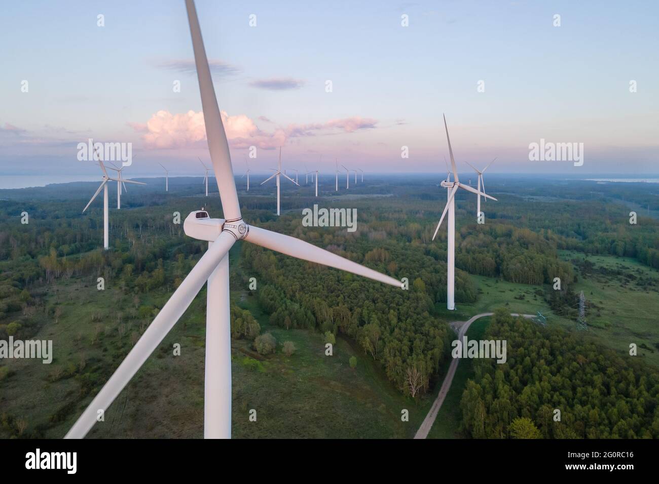Wind turbines on sunset at summer evening. Renewable energy Stock Photo ...