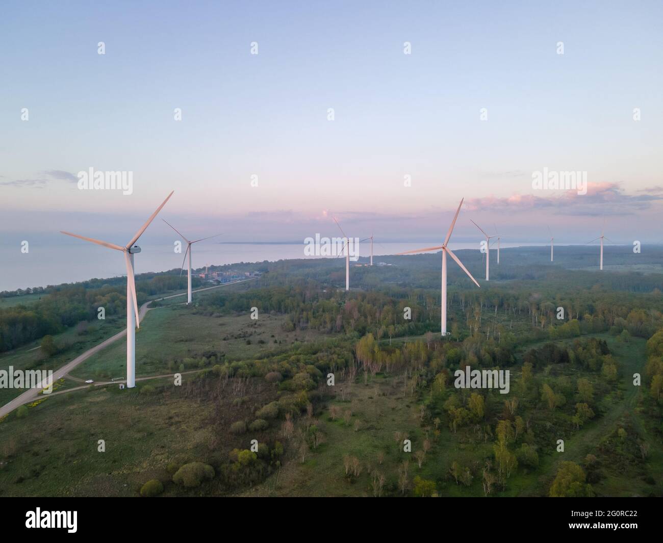 Wind turbines on sunset at summer evening. Renewable energy Stock Photo ...
