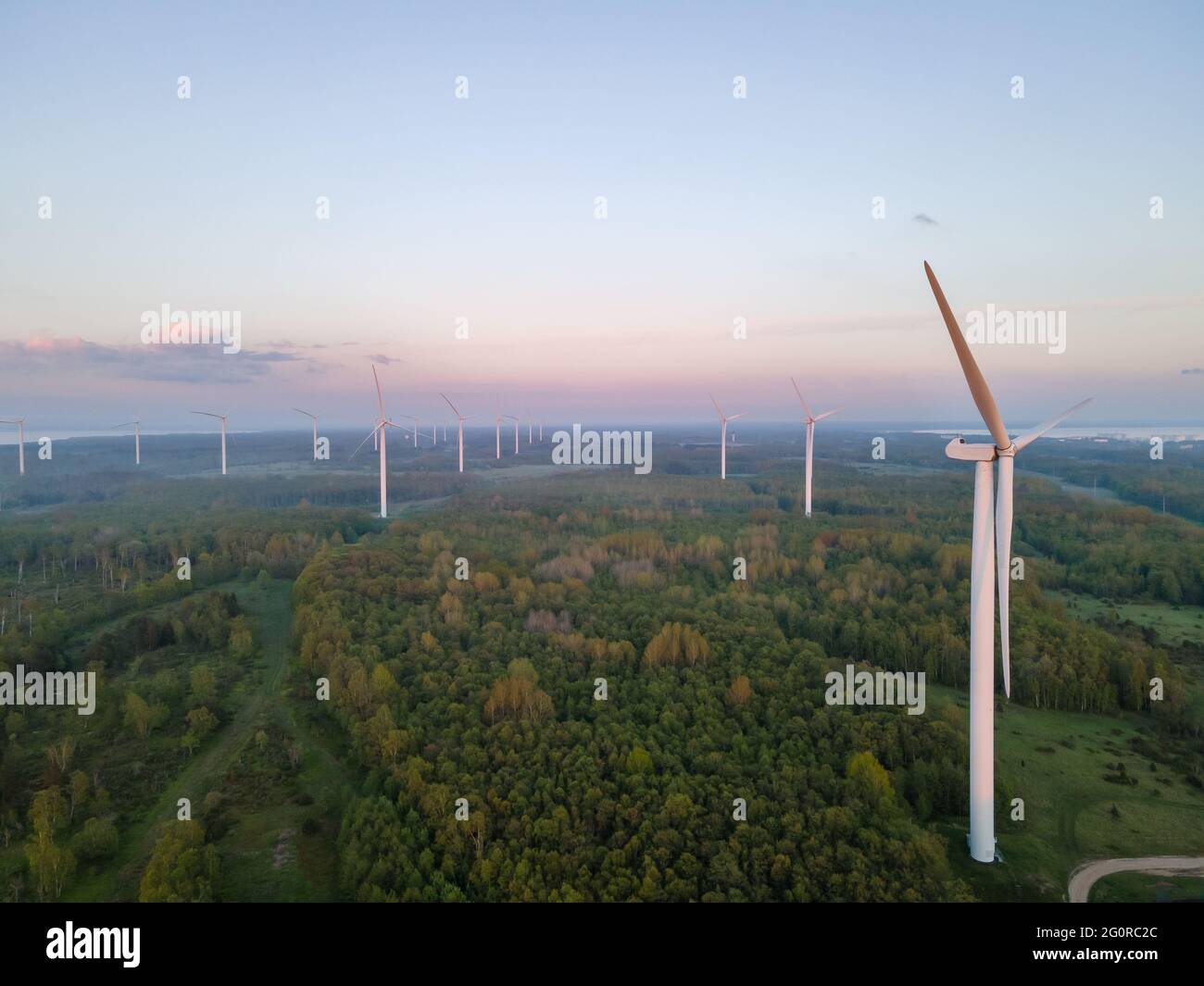 Wind turbines on sunset at summer evening. Renewable energy Stock Photo ...