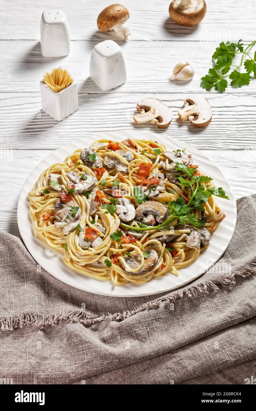 Italian spaghetti with cremini mushroom sauce of heavy cream and parmesan cheese with crispy