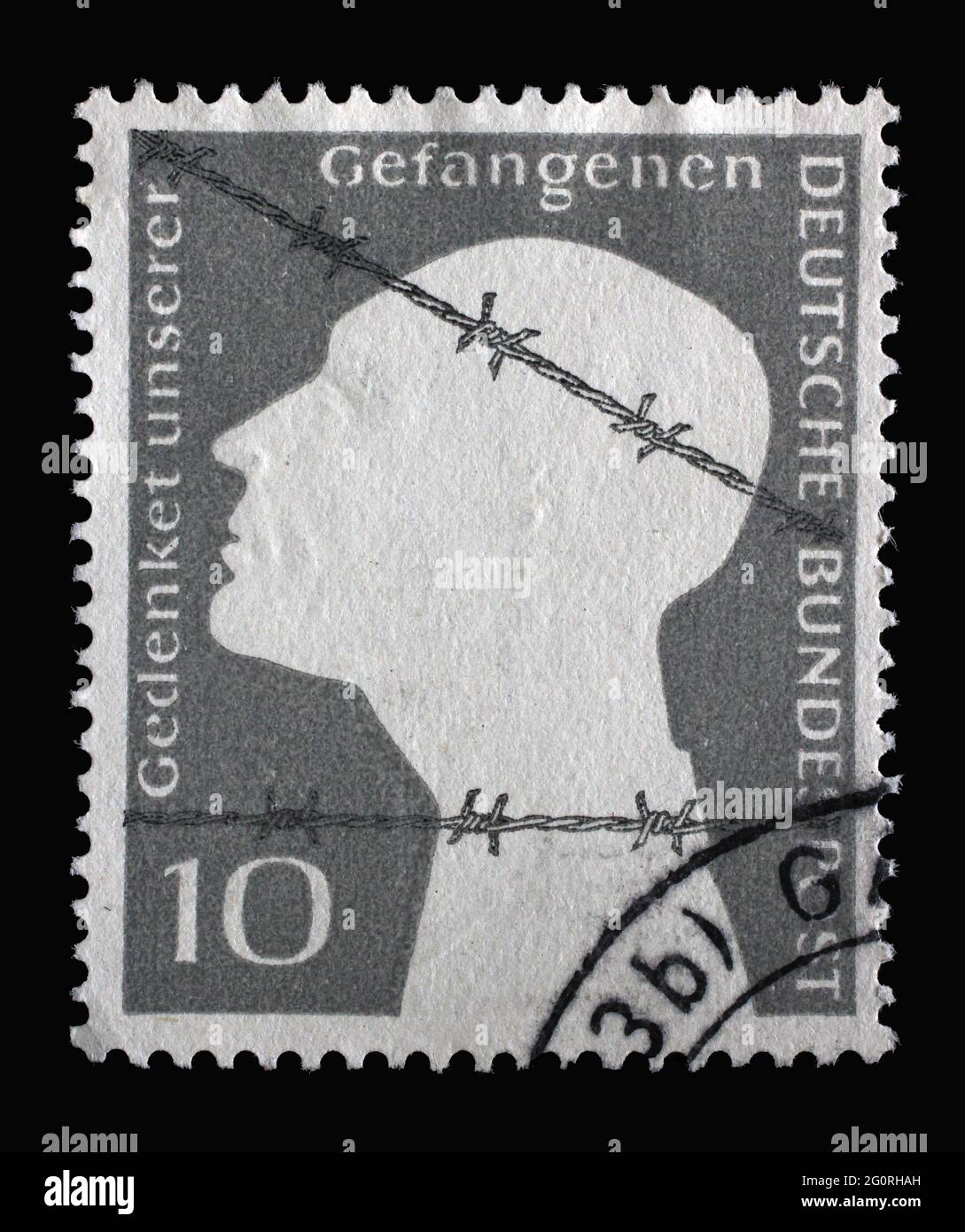 Stamp printed in Germany, shows Memorial Edition of War Prisoners, Prisoner behind barbed wire, circa 1953 Stock Photo