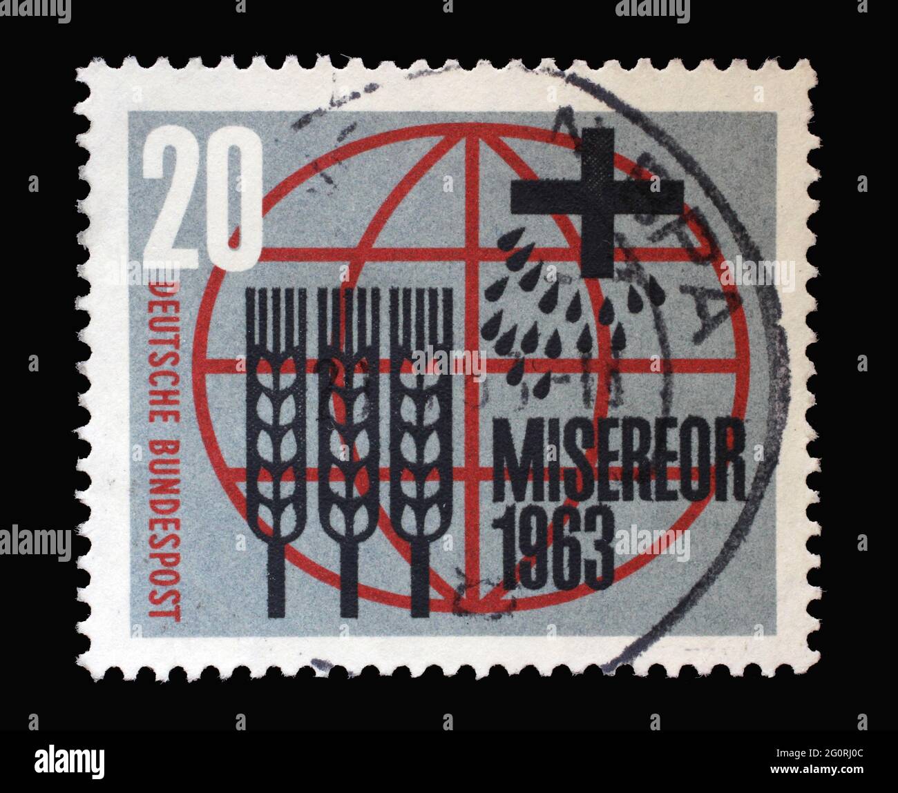 Stamp printed in Germany showing Stylized ears of corn, grains, cross and inscription in front of the globe honoring Miserior freedom from hunger, cir Stock Photo