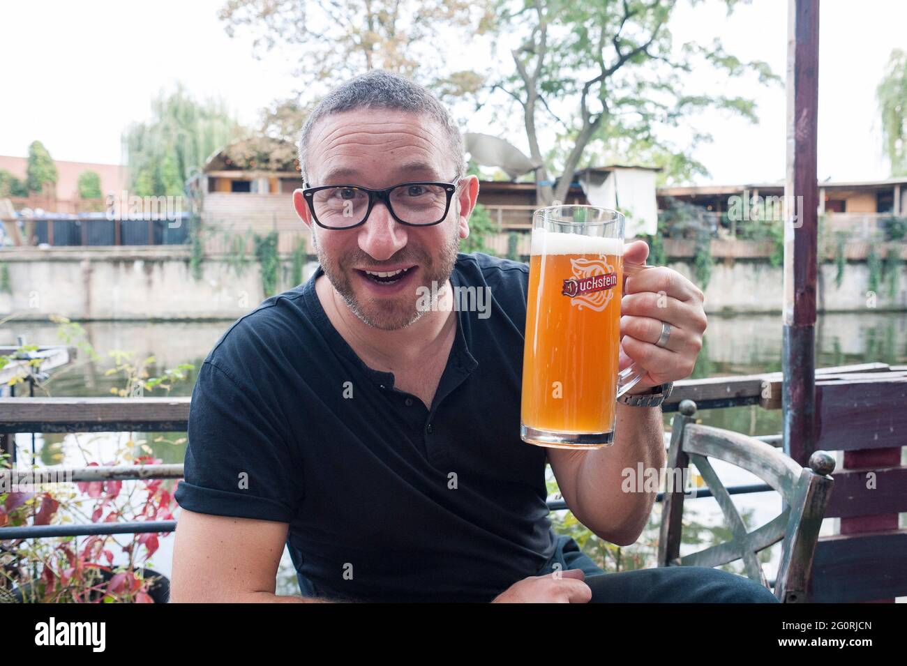 Enjoying traditional street food / restaurants in Berlin Germany and drinking beer Stock Photo