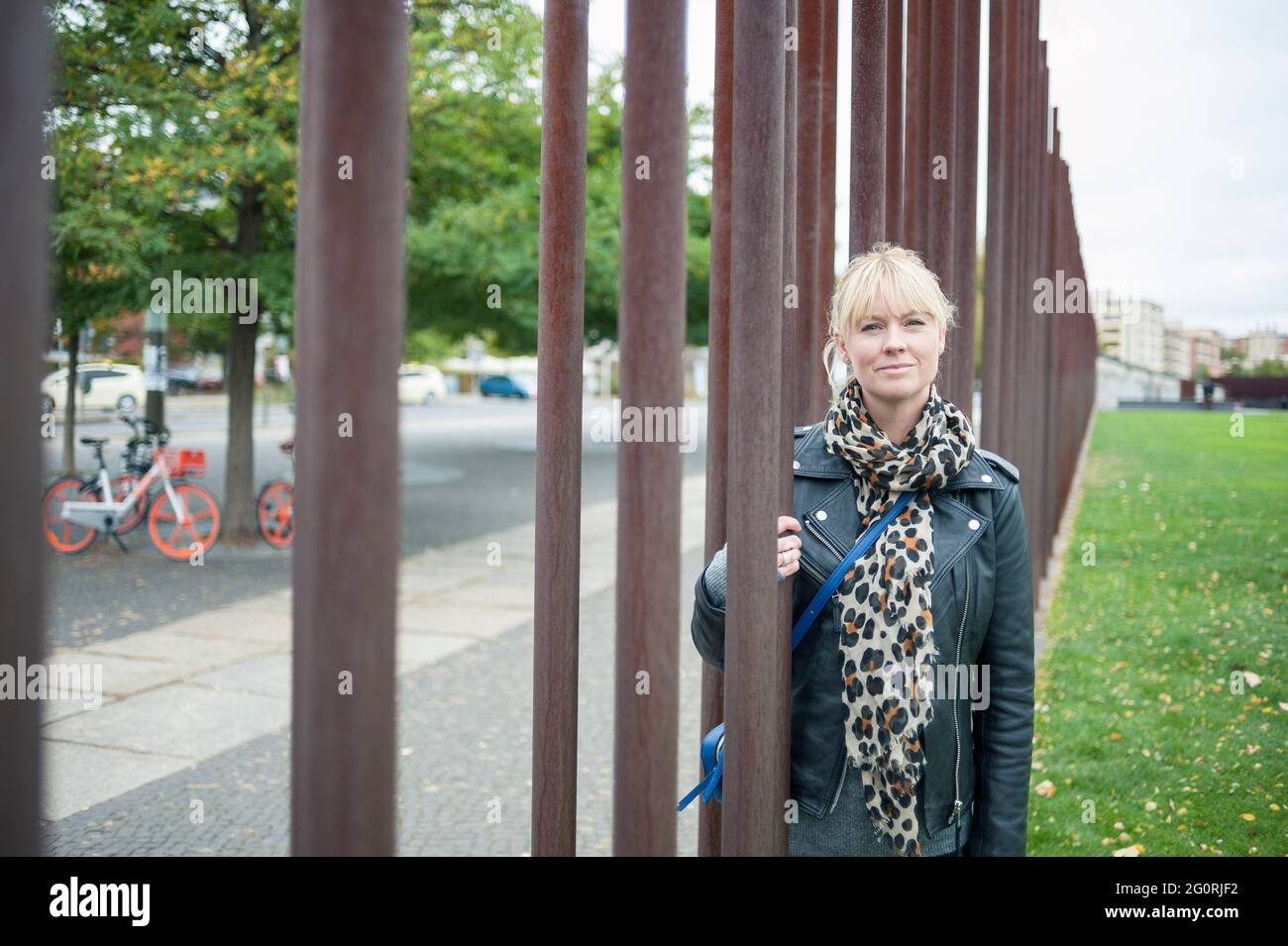 A real person standing and looking at the Berlin Wall on a city break vacation Stock Photo