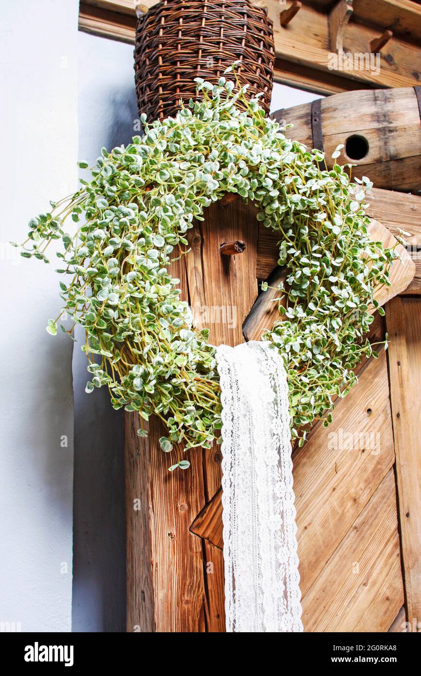 Easter wreath on wooden door. Spring home decorations. Stock Photo