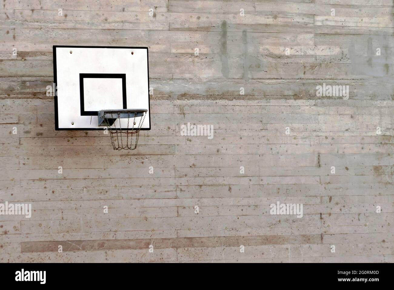 Cement wall with a basketball hoop with a lot of copy space Stock Photo