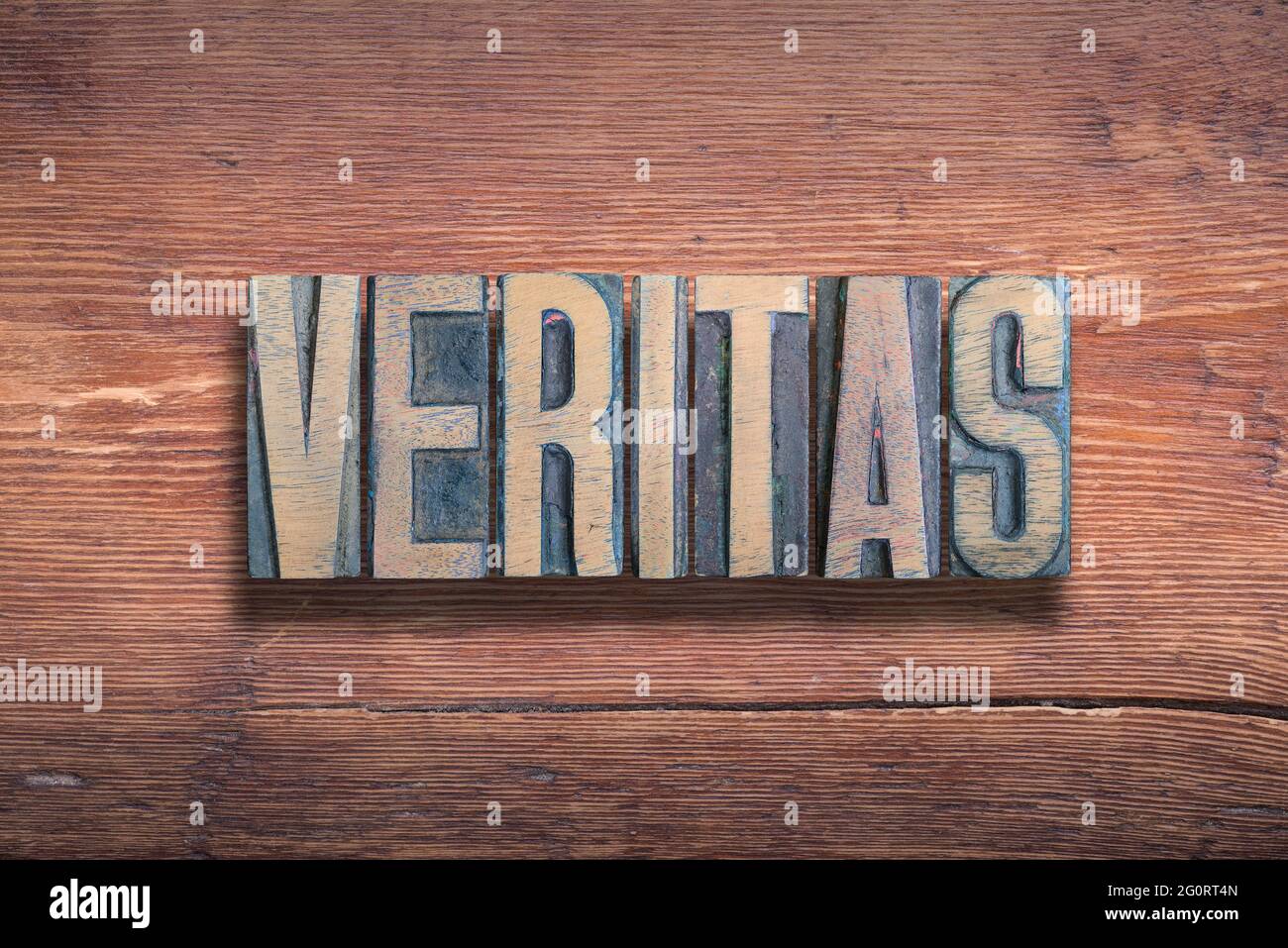 veritas ancient Latin word meaning - truth, combined on vintage varnished wooden surface Stock Photo
