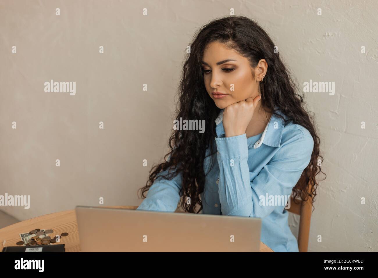 Young woman plans her expenses uses computer and special programs for ...