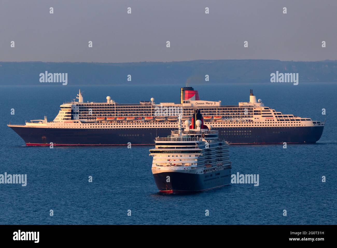 The Queen Mary 2 Queen Victoria Cruise Ships Are Pictured Alongside Each Other Whilst Anchored Off Babbacombe Torbay Devon Stock Photo Alamy