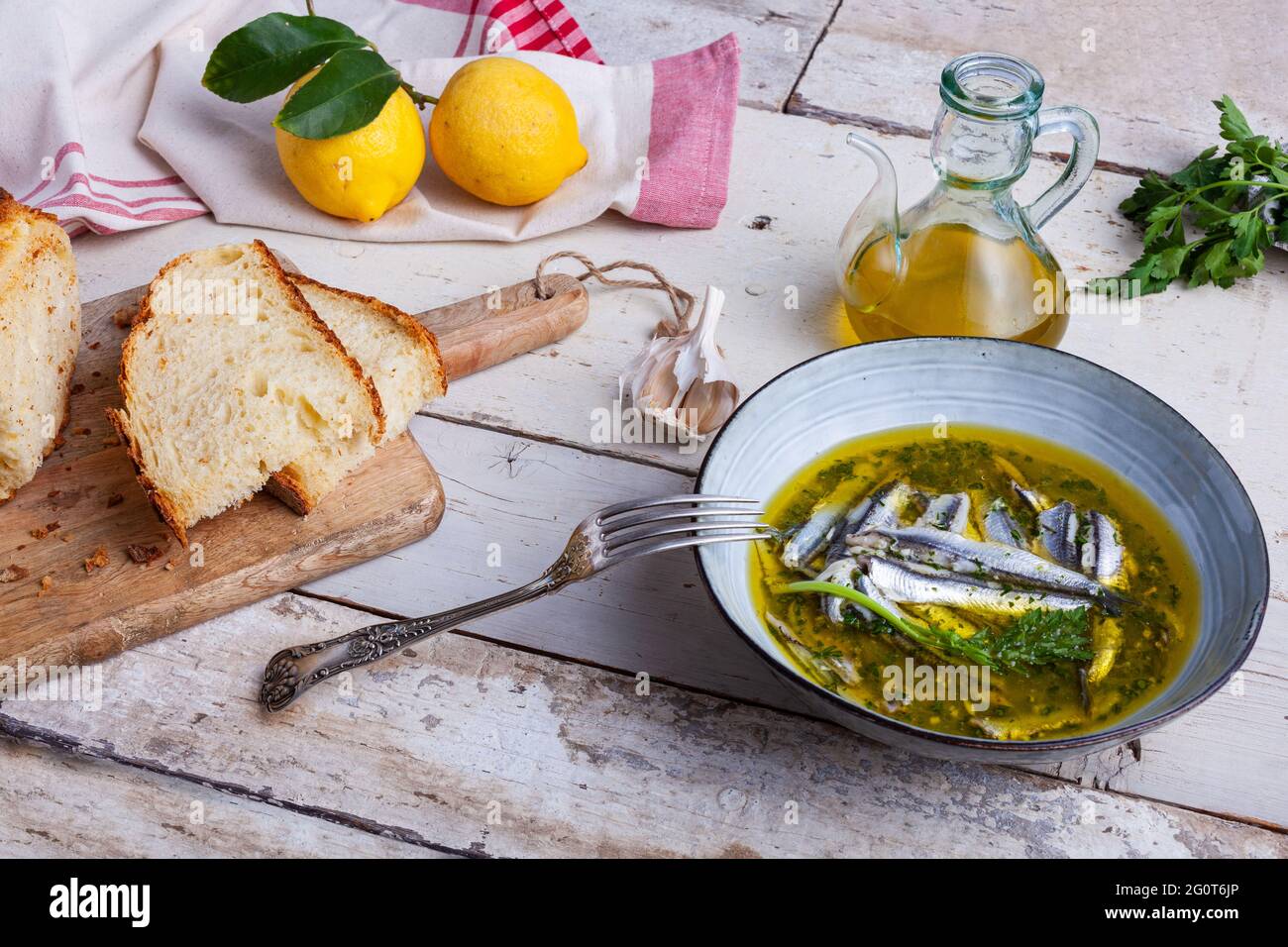 Marinated anchovies in lemon juice with olive oil garlic and parsley. Traditional mediterranean