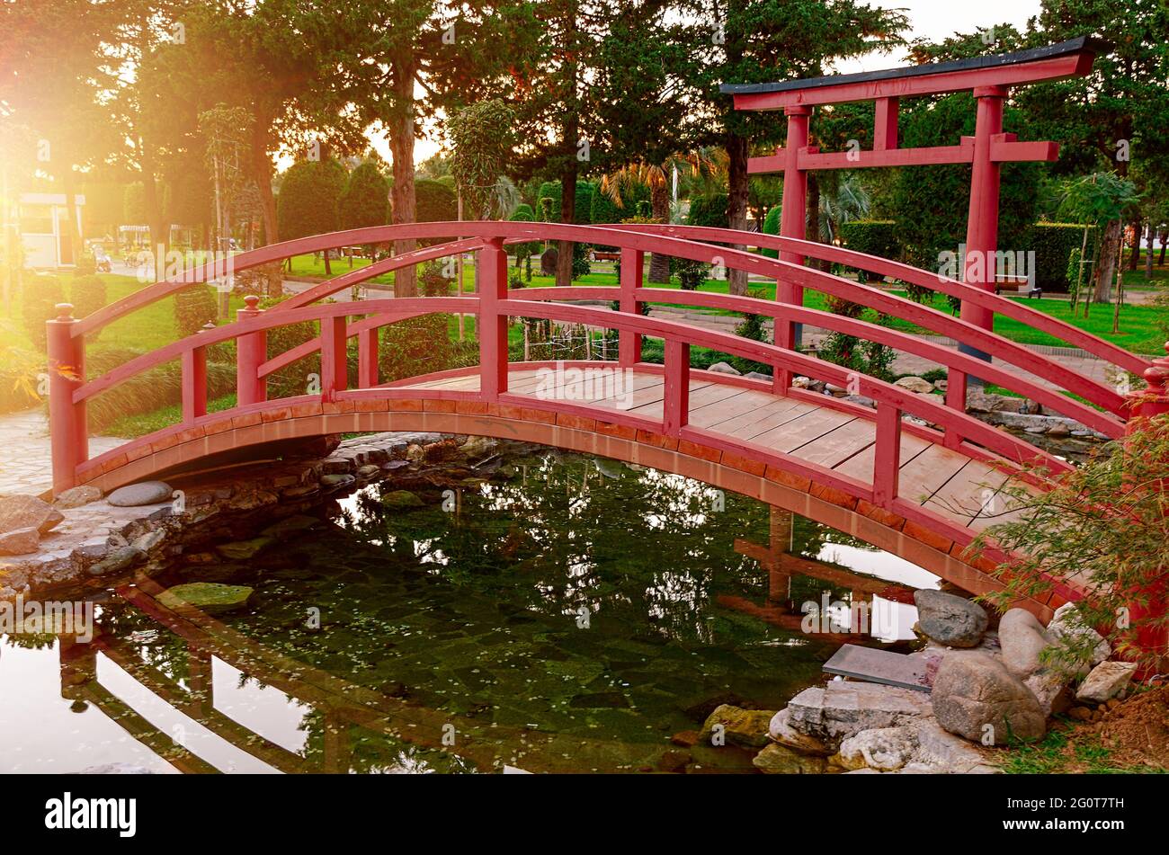 Wooden bridge in a park. Summer day in city park. Stock Photo