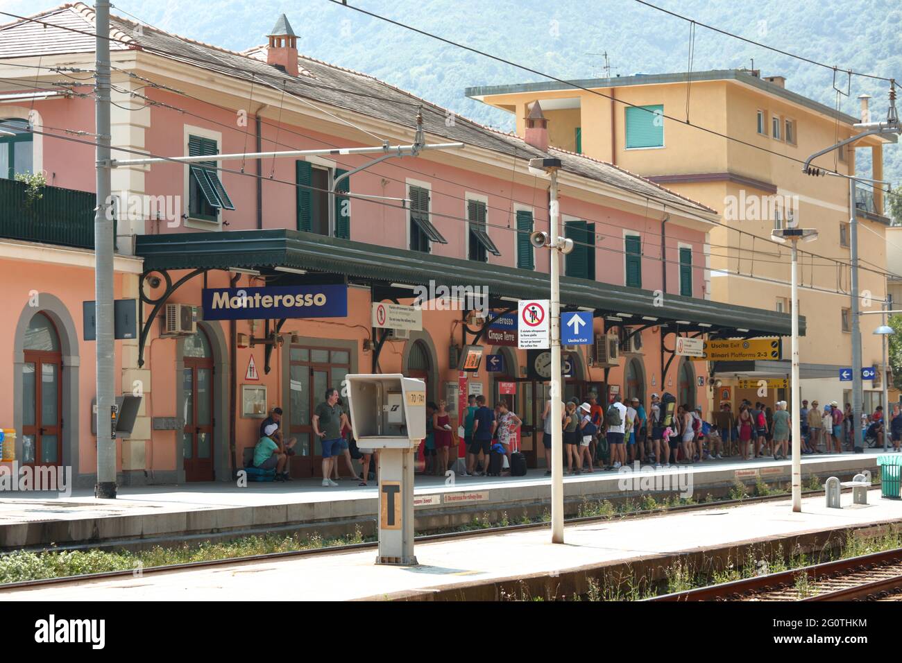 Tourists waiting a train on Monterosso railroad station, La Spezia, Italy. . Tourists prefer to travel in Cinque Terre national park by train Stock Photo