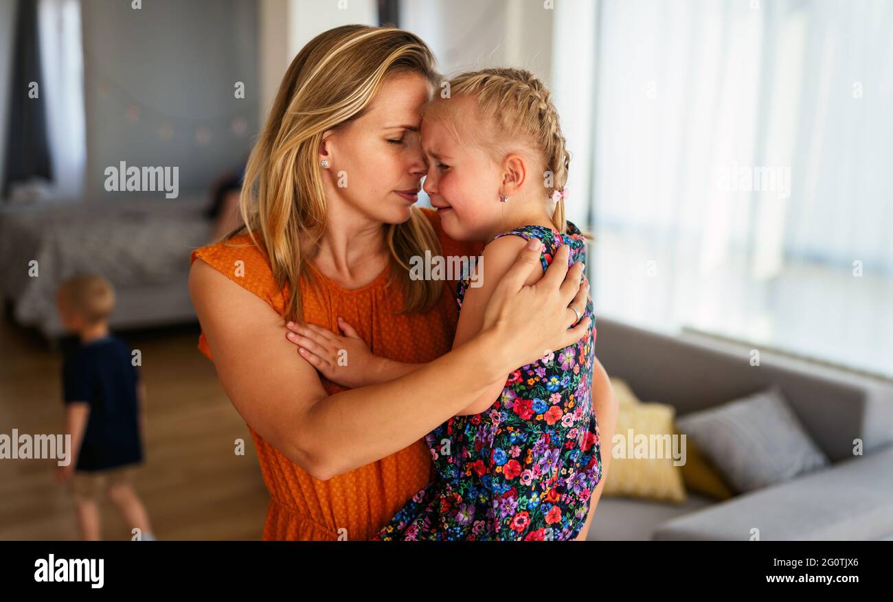 Mother comforting her crying little girl. Parenthood, family, support concept Stock Photo